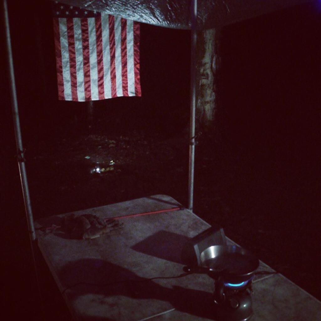 Photo: Cooking burgers under the tarp Photo: Cooking burgers under the tarp